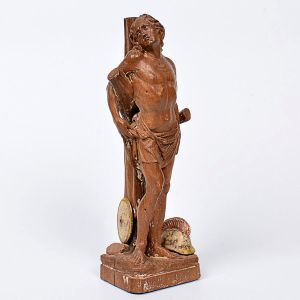 Imagem de <b>São Sebastião </b>em madeira entalhada e policromada. Aos pés o capacete representando a entrega de sua vida a fé cristã. Muito boa erudição com características neoclássicas. Olhos em contas. Séc. XVIII. Alt. 24 cm