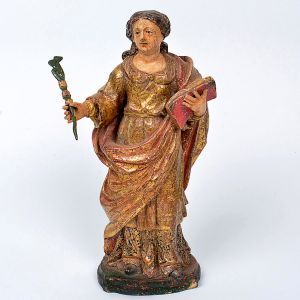 Linda imagem de <B>Santa Quitéria </B>em madeira entalhada, com vestes em rica policromia. À mão esquerda traz uma palma, símbolo do martírio e à direita o evangelho. Fina douração de época. Séc. XVIII. Alt. 28 cm