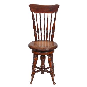 <b>Cadeira </b>em madeira, apresentando encosto com haste curva superior e palitos verticais ornamentados. Assento redondo e base apoiada sobre quatro pés torneados, ligados por travessas centrais. Alt. 94 cm