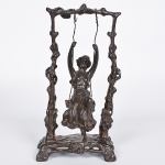 <b>Auguste Moreau</b><Br>(1834-1917)<Br>"Girl on Swing"<Br>Escultura em bronze patinado, representando jovem em balanço, sustentado por estrutura de galhos estilizados. <Br>Assinada na base. <Br>Alt. 23 cm