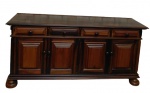 <b>Buffet </b>em jacarandá com quatro portas almofadadas e quatro gavetas superiores, adornadas por molduras em relevo e puxadores torneados no mesmo material. Tampo liso de linhas retas.