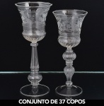 <b>Conjunto de 37 copos </b>em cristal lapidado com gomos e decorados com frisos e flores gravados, sendo 20 maiores e 17 menores. Alt. 23 e 21 cm