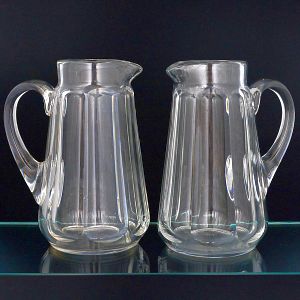 <b>Par de jarras </b>em cristal francês "Baccarat" lapidadas em facetas no modelo "Harcourt". Marcas da "Christalerie" nas bases. Alt. 22 cm