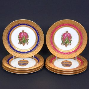 Raro e elegante <b>conjunto de 8 pratos </b>de jantar em porcelana Fine China, Fabergé. Cada peça decorada com representação distinta de ovos imperiais da Casa Fabergé, em cores intensas e riquíssimos detalhes em ouro. Bordas com ampla faixa em ouro adamascado, com aplicações em azul, vermelho e rosa, formando um conjunto harmonioso e luxuoso.