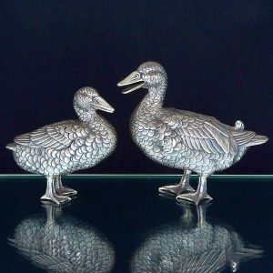 <b>LUIZ FERREIRA e DAVID FERREIRA - "Pendant" de patas</b>, em prata portuguesa finamente texturizada naturalisticamente. Cada qual com asas em seus dorsos. Olhos em contas. Contraste da cidade do Porto e dos mencionados ourives. Compr. da maior 19 cm; Alt. da maior 16,5 cm; Compr. da menor 14 cm; Alt. da menor 13,5 cm. Peso 610 gramas.