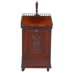 Belo e inusitado <B>móvel para guarda de carvão</B>, usado junto a lareiras. Peça de origem inglesa vitoriana, construída em mogno. Frente com compartimento interno e entalhado com roseta na superfície. Puxadores em bronze de época e parte posterior apresentando uma pá em latão com cabo torneado. Séc. XIX. Med. 58 x 34 x 38 cm