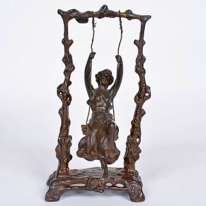 <b>Auguste Moreau</b><BR>(1834-1917)<BR>"Girl on Swing"<BR>Escultura em bronze patinado, representando jovem em balanço, sustentado por estrutura de galhos estilizados. <BR>Assinada na base. <BR>Alt. 23 cm