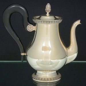 <b>Bule para café</b>, de bojo abaulado, em metal prateado Christofle. Tampa coroada por pináculo modelado em gomos, bico vertido e pegador em madeira curva. Alt. 22 cm