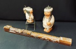 Conjunto de 1 flauta boliviana e 2 figuras de índios chilenos de argila vermelha maior de 18 cm e menor com 12 cm. A flauta tem marcação em relevo "BOLIVIA", mede 49 cm.
