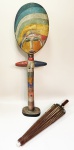 Duas curiosas peças sendo uma escultura em madeira pintada em figura feminina "LUA" policromada em base oval com 73 cm de altura. Outra uma sombrinha estilo oriental em papel pintado em borboletas e varetas de bambú com 55 cm de comprimento e 80 de diâmetro. Obs: papel com 2 pequenos furos, venda no estado.