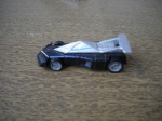 Carro em miniatura - HOT WHEELS 1999 - Em metal, com as rodas em borracha - Cores preta e prata - Dimensões 8,00 X 3,00 cm - Ótimo estado de conservação - Procedência dos Estados Unidos