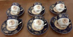 Seis xícaras em porcelana tcheca decorada com cena familiar em reserva, guirlandas e filetes a ouro 24k.