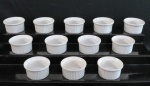 Doze (12) ramequins em porcelana branca. Marcada C. Cerqueira Leite modelo Brasil Trade Mark. Med. 3,5 x 7 cm.