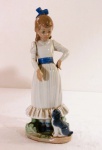 NAO by LLADRO- Escultura em fina porcelana espanhola, com marca da manufatura, representando "Menina e cão" em rica policromia. Marcado, datado e assinado DAISA na base 1983. Perda no dedo polegar da mão direita. Med. 24,5 cm alt.