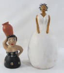 Duas (02) bonecas decorativas em terracota, uma com cabelo em arame encaracolado e uma com vestes no tom preto com moringa na cabeça. Uma marcada Eliza Bravim/Wagner Freitas com restauro na cabeça ( 37 cm alt), uma marcada Mãos de Minas com restauro na moringa ( 27 cm alt).