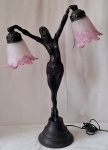 ART NOVEAU- Luminária de mesa para duas luzes em resina representando " Bailarina". Cúpulas em vidro fosco no tom rosa. Med. 67 x 45 cm. Restauro na perna esquerda e mão direita colada.