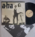 LP A-HA - EAST OF THE SUN WEST OF THE MOON C/ ENCARTE // CAPA CONFORME FOTOS // DISCO EM MUITO BOM ESTADO // PODE CONTER RISCOS QUE CAUSAM CHIADOS, RUÍDOS OU PULOS