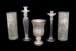 Lote constando de cinco peças decorativas em vidro moldado, sendo um par de vasos decorados em craquele e pátina prateada - med. 28x10 cm de diâmetro na borda ( uma com imperceptível bicado na borda), um vaso com pátina prateada com base redonda - med. 22x14 cm de diâmetro na borda, e dois castiçais sendo um com parte superior na forma de flor, haste frisada e base redonda - med. 30x10 cm de diâmetro na base e um castiçal com haste frisada e base redonda - med. 34x10 cm de diâmetro de base (copo superior de apoio para vela colado)