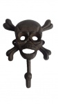 Gancho e abridor de garrafas, em ferro fundido com imagem de caveira para fixar na parede.