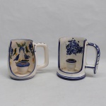 Dois castiçais em porcelana branca e azul: A) Decorado com flores e folhagens coloridas. Marcado LUIZ SALVADOR - ITAIPAVA. Alt. 12 cm. B) Decorado com flores, lascado na borda. Alt. 12,5 cm.