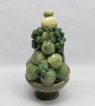 Floreira em porcelana na cor verde, representando fruteira redonda e frutos. Marcado LUIZ SALVADOR - ITAIPAVA. Alt. 30 cm.