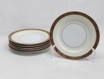 NORITAKE - Seis pratos para pão em porcelana japonesa decorada com faixa creme, borda em ouro brunhido e canetado em preto com flores e folhagens. Marca da Manufatura no fundo. Diam. 16cm.