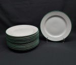 Doze pratos rasos em porcelana branca, borda decorada com faixa verde. Marcado GERMER. Diam. 25 cm.