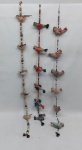 Três mobiles em contas e tecido, representando pássaros. Alt. 80 cm.