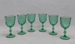 Seis taças p/ vinho tinto em vidro verde, base redonda, haste balaustre e bojo moldado no padrão dedão. Alt. 15 cm.