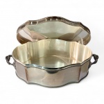 METAL PRATEADO INGLÊS - Grande caixa em formato oblongo-ondulada em metal prateado, com tampa articulada e alças laterais.Caixa de mesa ou aparador, formato oblongo de bordas sinuosas, decorada com frisos torcidos no contorno da tampa e da base. Pegas laterais em volutas e folhagens. Interior liso, tampa articulada (necessita solda).Apresenta desgaste acentuado na parte superior. Os flancos e parte posterior, anterior e interior da peça estão em bom estado geral de conservação.Marcas de fabricante gravadas na base: DF Y S 3624 D, correspondendo a manufatura inglesa de metal prateado (silver plate), possivelmente Deepe & Sons, século XX.Dimensões: 42 cm x 35 cm x 13 cm de altura.