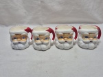 Jogo de 4 canecas em porcelana na forma de Papai Noel. Medindo 8cm x 8cm de altura.