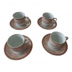 Quatro xícaras para café em porcelana Schmidt, decoração em grega e flores na cor goiaba sobre fundo branco, uma delas com leve bicado na borda,  5 x 5 cm.