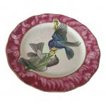 COLECIONISMO - Prato em porcelana francesa com fundo representando pássaros e flores, bordas rajadas e frisos dourado, marcado na base, Diam. 23 cm.