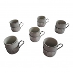 Seis xícaras em porcelana Pozzani com filetes prateados com suporte espessurado à prata, 6 x 5 cm.