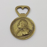 Antigo Abridor de Garrafa, Formato Medalhão Comemorativo, D.João V, Rei de Portugual e dos Algarves, Em Bronze. Medidas: Altura: 9 cm, Comprimento: 5,5 cm, Peso: 105 g.
