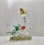 Escultura em vidro artístico Murano, pássaros multicoloridos. Delicada escultura em vidro artístico de Murano, representando três pássaros pousados em base orgânica translúcida. As figuras, modeladas manualmente, exibem elegantes nuances em tons de âmbar, verde-água e vermelho alaranjado, com perfeita transparência e movimento fluido característico do vidro soprado veneziano. Altura:   20 x 18 x 13 centímetros.