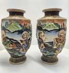 Par de vaso em cerâmica japonesa Satsuma, ricamente decorado em relevo esmaltado e douração policromada, apresentando cena com figuras de sábios orientais diante de paisagem montanhosa com pagodes e lagos, em composição de notável riqueza simbólica e detalhamento artesanal.A peça exibe o característico fundo creme craquelado e decoração em alto relevo (moriage) com esmaltes em tons de azul, verde, vermelho e ouro, sobre fundo negro.Produção japonesa da primeira metade do século XX, inspirada nos estilos Meiji tardio e Taish. Dimensões:  38x22 centímetros cada.