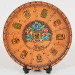SOUVENIR, um (1) prato decorativo, ornado com Brasões de Cidades Austríacas, origem WIEN (Viena),confeccionado em madeira torneada, para fixação em parede, medindo 20 cm diâmetro, vide foto.