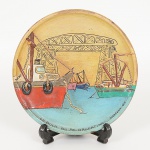 SOUVENIR, um (1) prato decorativo para fixação em parede, pintado a mão em policromia representando LABOCA, Argentina, assinado e datado Marcela 84, confeccionado em madeira torneada, apliques em cordoamento eoutros elementos na composição, medindo 14,5 cm diâmetro, vide foto.