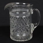 VIDRO, uma (1) imponente jarra, incolor e translúcida, lapidada em sulcos, caneluras e treliças, medindo 22 cmaltura, sinais de uso, vide foto.