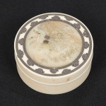 MARFIM, uma (1) antiga caixa cilíndrica, tampa com apliques em madrepérola e prata representando flores,medindo aproximadamente 6,5 cm diâmetro e 3 cm altura, sinais de uso, vide foto.