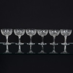 CRISTAL INGLÊS, seis (6) taças de pé alto para champanhe ou espumante, incolores e translúcidas, bojo lapidadoem sulcos e dedão, fuste hexagonal, base em bolacha, manufatura da Cristaleria STUART, modelo similar aoBACCARAT, medindo 11,5 cm altura, sinais de uso, vide foto.