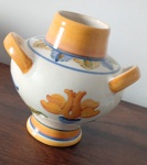 Vaso em faiança  policromado com três  Alças na cor abobora borda superior com folha laterais com flores marcado na base  LS.