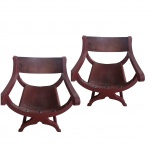 Par de cadeiras  Savonarola em madeira nobre patinadas em tom de vermelho patinado de couro,uma delas necessitando restauro no couro do encosto .