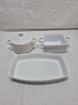 Travessa retangular e 2 potes sendo 1 com tampa em porcelana branca. Medindo a travessa 19cm x 12cm x 3cm de altura.