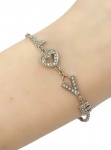 Pulseira em Ouro Branco 18Kt  LOVE com Brilhantinhos, Totalizando aproximadamente 0,25CT Medindo: 15Cm - Peso:3,70GR