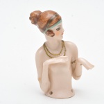 Coleção Half Doll - Dama com cabeça inclinada e expressão elegante. Pequena perda nas pontas dos dedos e braço restaurado. 7,5x5 cm.