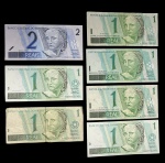 Lote misto de cédulas brasileiras da primeira família do Real, incluindo notas de 1 e 2 Reais, em variados estados de conservação.