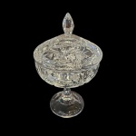 Bombonière em cristal europeu lapidado, pega em diamante, apoiada em haste apoiada em base circular, Alt. 26, Diam. 15 cm.