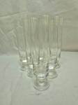 Jogo de 6 taças longas flute em cristal incolor com pé disco. Medindo 5cm x 17,5cm de altura.